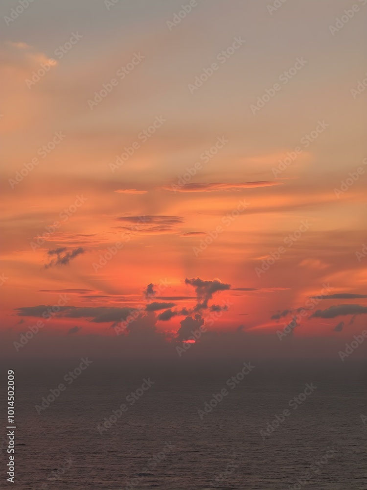 The sky at sunset, with vivid orange and red tones reflecting on the water and distant clouds catching the last rays of the sun
The sky at sunset, with vivid orange and red tones reflecting on the water and distant clouds catching the last rays of the sun