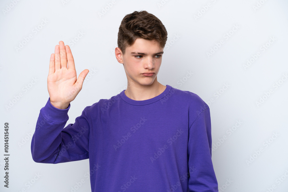 Teenager Russian man isolated on white background making stop gesture and disappointed Teenager Russian man isolated on white background making stop gesture and disappointed