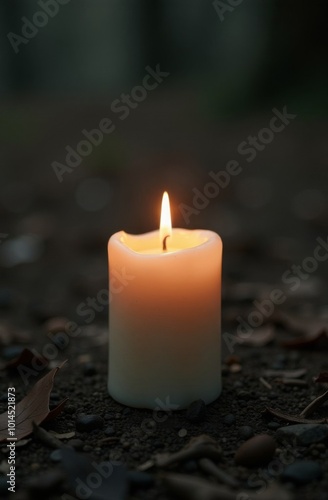 Lit Candle in a Peaceful Outdoor Setting at Dusk