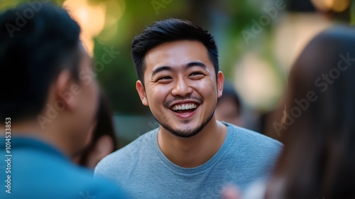 A Young Man Smiles Cheerfully at a Friend