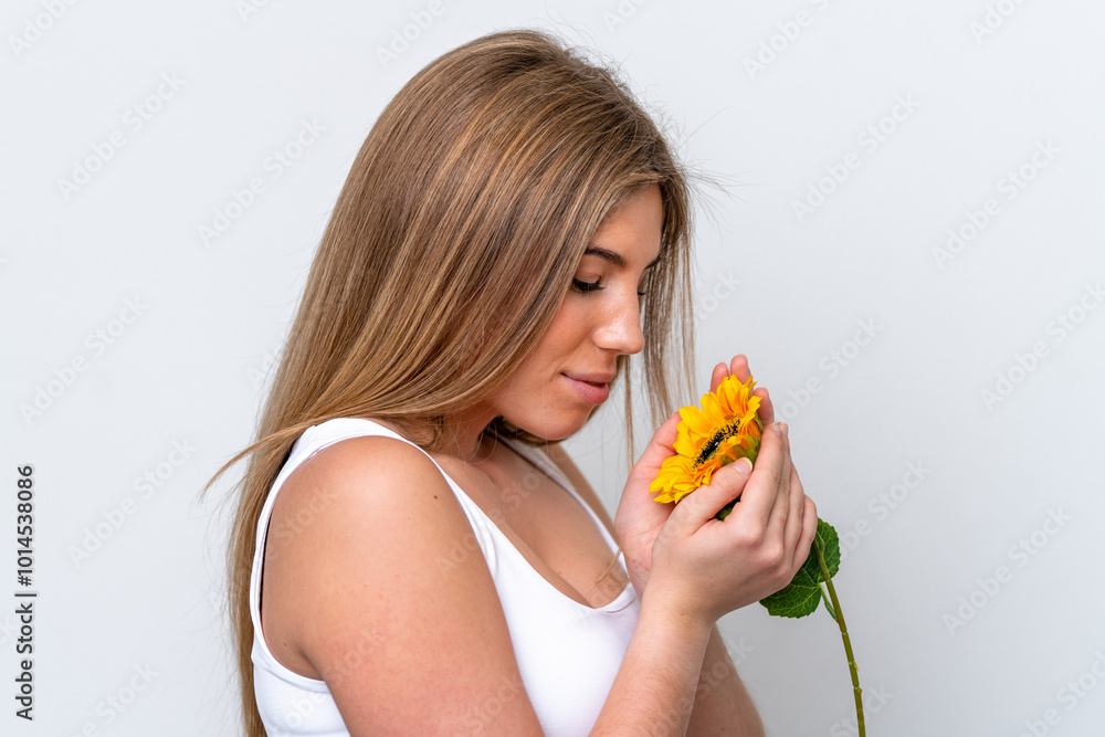 Young caucasian woman isolated on white background holding a sunflower. Close up portrait Young caucasian woman isolated on white background holding a sunflower. Close up portrait