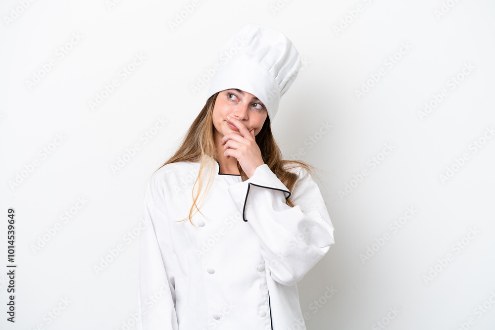 Young caucasian chef woman isolated on white background having doubts and with confuse face expression Young caucasian chef woman isolated on white background having doubts and with confuse face expression