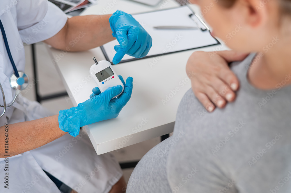 The doctor checks the blood sugar level of a pregnant patient. Gestational diabetes. The doctor checks the blood sugar level of a pregnant patient. Gestational diabetes.