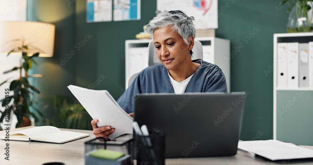 © LuxeShutter24/peopleimages.com - Doctor, laptop and mature woman with paperwork in office for healthcare, research or patient records. Medical professional, reading and work with info by tech for diagnosis review, report or feedback