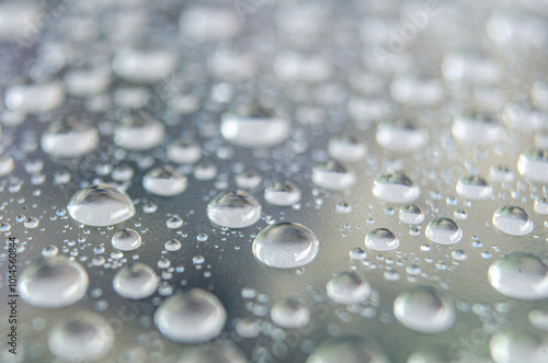 Side angle of clear raindrops on a transparent surface. Rain reflections theme