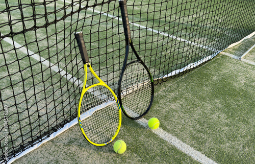 Tennis racket and tennis ball on court.