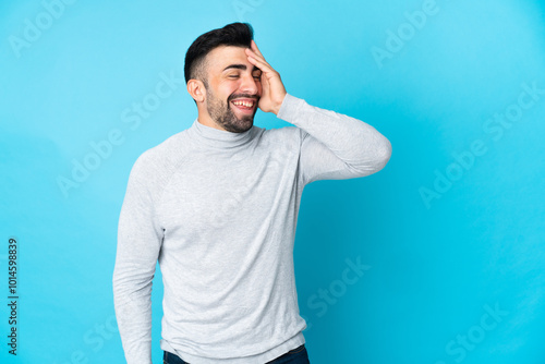 Caucasian man over isolated blue background smiling a lot