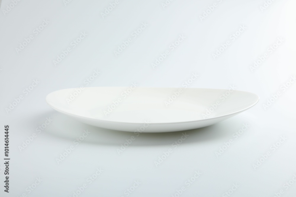 One empty ceramic plate isolated on white One empty ceramic plate isolated on white
