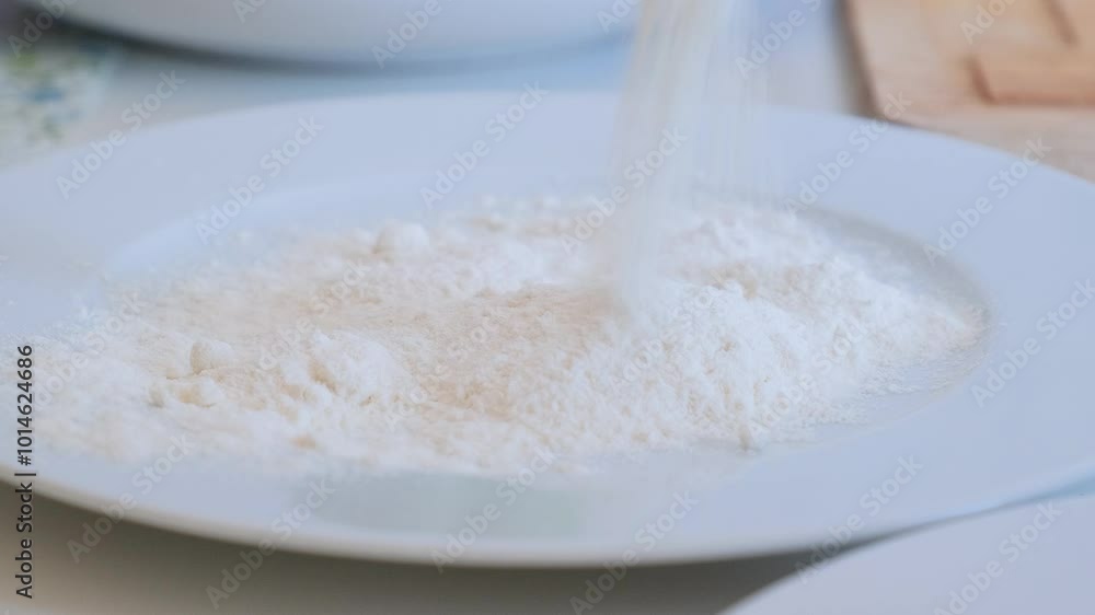 Flour is poured onto a plate Flour is poured onto a plate