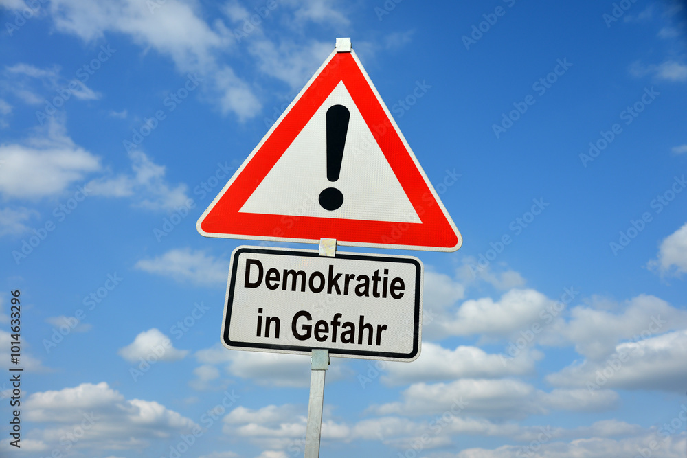 Burgdorf, Lower Saxony, Germany - January 16, 2024: Traffic warning sign saying Democracy in danger (in German Demokratie in Gefahr) Burgdorf, Lower Saxony, Germany - January 16, 2024: Traffic warning sign saying Democracy in danger (in German Demokratie in Gefahr)