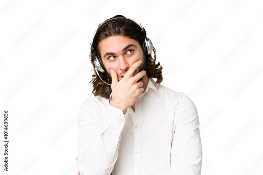 Telemarketer man working with a headset over isolated chroma key background having doubts and with confuse face expression Telemarketer man working with a headset over isolated chroma key background having doubts and with confuse face expression