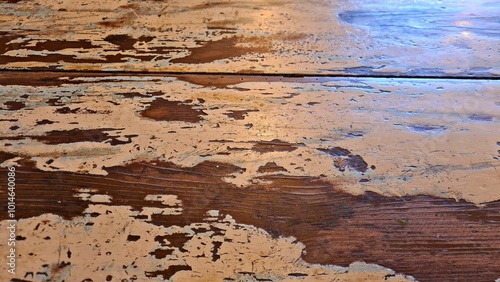 An old wooden table with remaining white paint on its surface