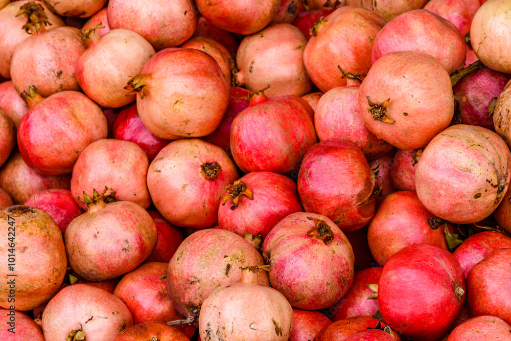 Many pomegranates for sale at the market. Fruit background Many pomegranates for sale at the market. Fruit background