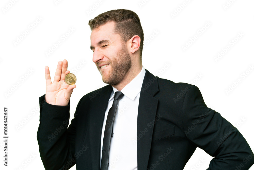 Young business blonde man holding a Bitcoin over isolated chroma key background suffering from backache for having made an effort Young business blonde man holding a Bitcoin over isolated chroma key background suffering from backache for having made an effort