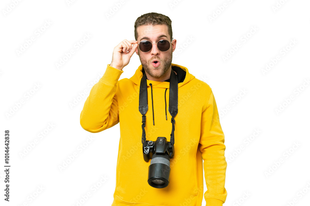 Young photographer man over isolated chroma key background with glasses and surprised Young photographer man over isolated chroma key background with glasses and surprised