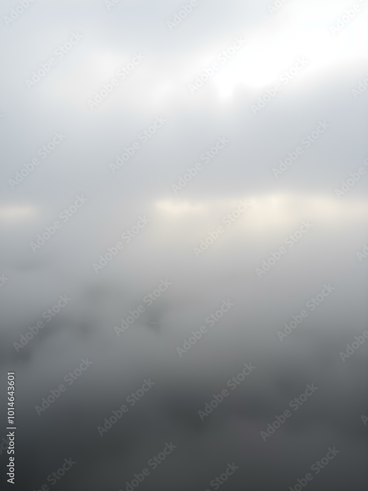 Fototapeta premium A soft, overcast sky with rolling fog moving across the landscape, creating a mysterious, dreamy atmosphere with light breaking through in soft beams