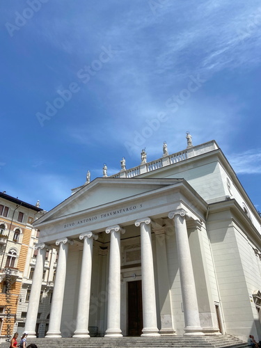 The largest Catholic church of San Antonio Nuovo in Trieste makes the viewer look up at the sculptures of saints in the halo of the blue, barely cloudy sky.