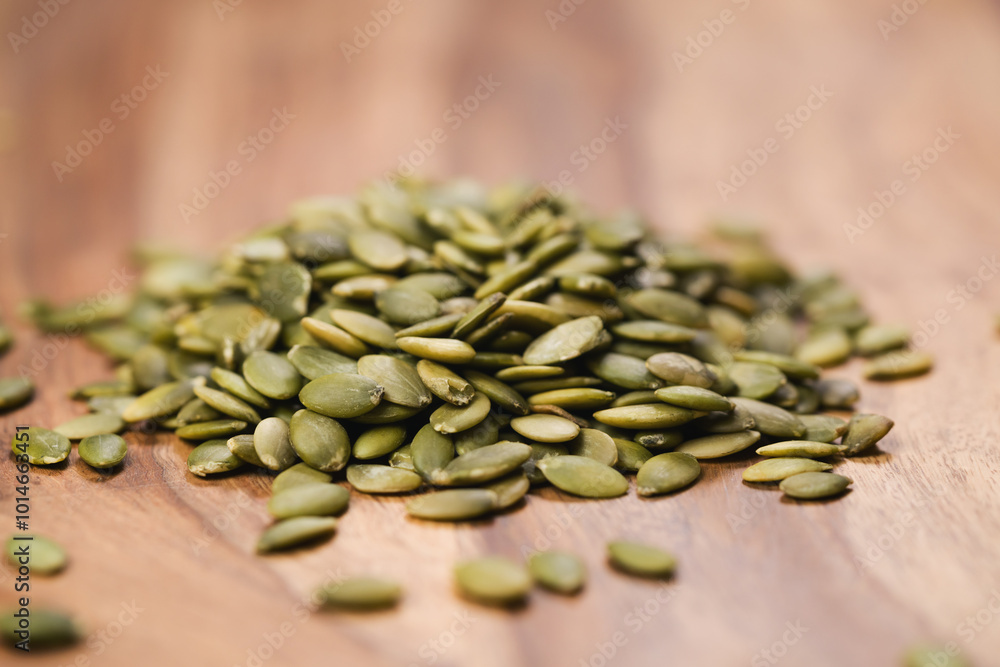 Obraz premium green pumkin seeds on wooden table