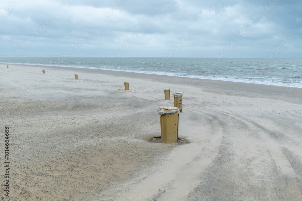 yellow garbage cans on the beach, north sea, Netherlands yellow garbage cans on the beach, north sea, Netherlands
