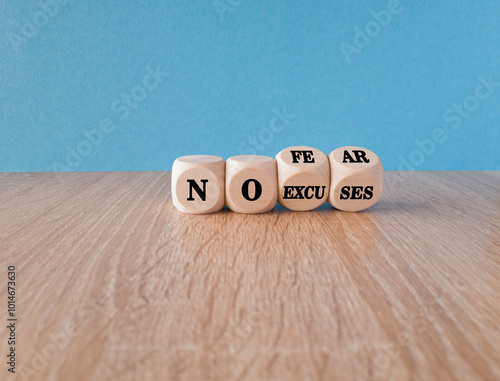No fear and excuses symbol. Concept words No fear No excuses on wooden cubes. Beautiful wooden table blue background. Business motivational no fear and excuses concept.