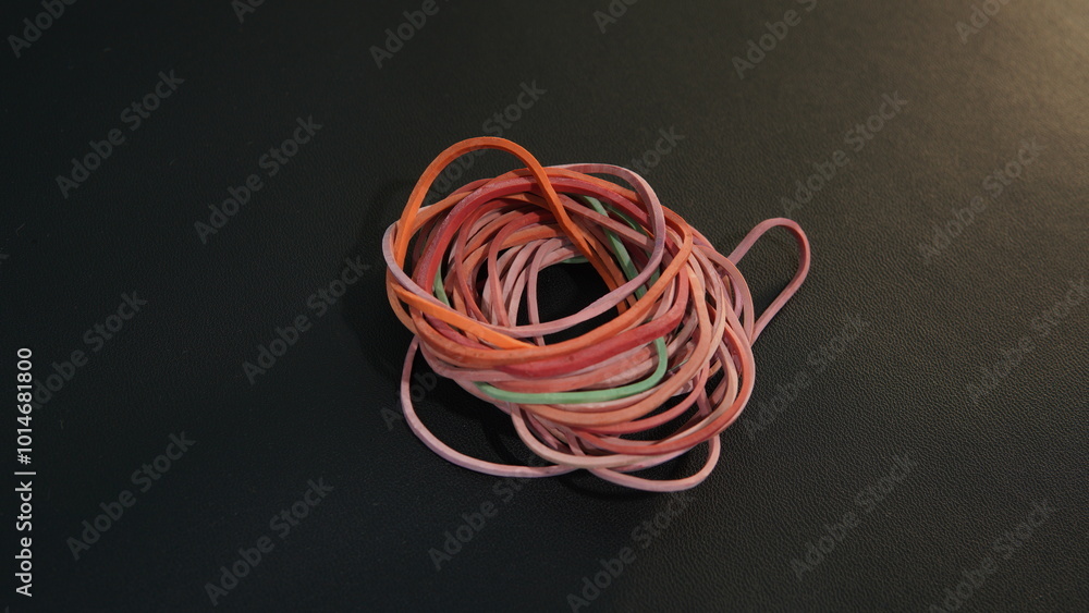 close up of colorful bands. several rubber bands on a black background close up of colorful bands. several rubber bands on a black background