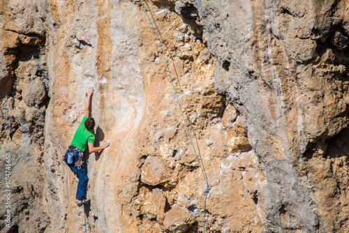 A rock climber ascends to the summit via a difficult route.