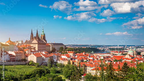 View of Prague featuring historic castle and vibrant rooftops on a sunny day in summer. Aerial view of Prague, Charles Bridge over Vltava river in Prague, Czechia. Old Town of Prague, Czech Republic.