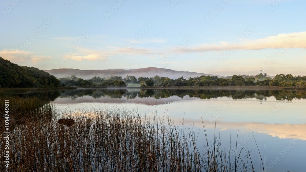 Beautiful morning lakeside landscape scenery, mountains reflected in Ross lake, county Galway, Ireland, nature background