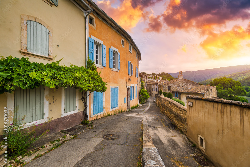 Charming street in quaint Menerbes village with colorful buildings and vibrant flowers. Village of Menerbes (Most Beautiful Village in France) in the Luberon mountains, France, Luberon, Vaucluse. Charming street in quaint Menerbes village with colorful buildings and vibrant flowers. Village of Menerbes (Most Beautiful Village in France) in the Luberon mountains, France, Luberon, Vaucluse.