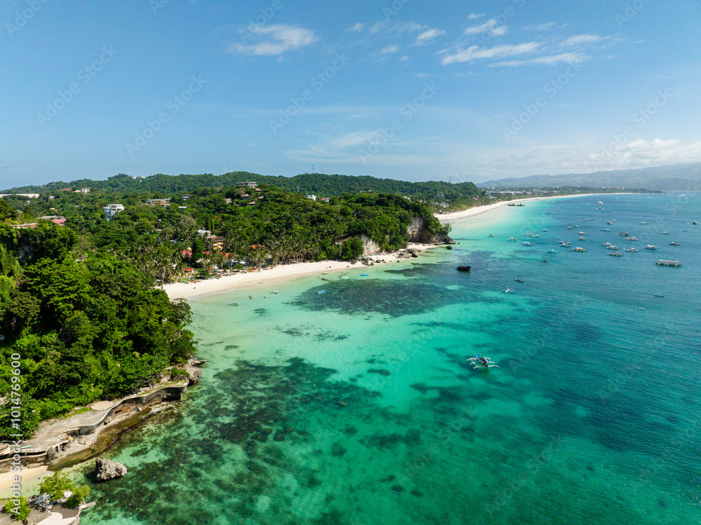 Fototapeta premium Diniwid Beach with coconuts trees, white sands and boats over turquoise sea water. Boracay, Philippines.