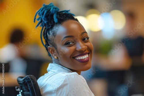 A happy woman with blue dreadlocks smiling directly at the camera