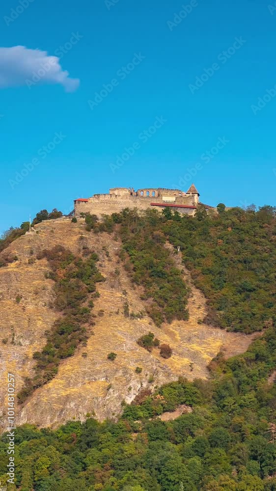 Nagymaros, Hungary - September 01, 2024: View to the Visegrad Castle from the other side of the Danube river. Time lapse, zoom out transition, vertical orientation. Nagymaros, Hungary - September 01, 2024: View to the Visegrad Castle from the other side of the Danube river. Time lapse, zoom out transition, vertical orientation.