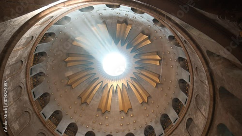 The camera swirls slowly pointing upwards, towards the ceiling dome at the Church of the Holy Sepulchre. a wide angle shot inside the holy Church. a 4K video clip, July 2nd, 2024, Jerusalem, Israel.