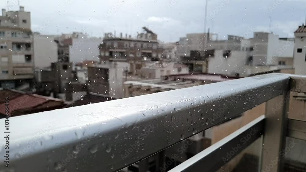 It's raining in slow motion. Raindrops close-up video. Raindrops on the balcony overlooking the city. It's raining outside in autumn. Rainy weather, cloudy, clouds. It's raining in slow motion. Raindrops close-up video. Raindrops on the balcony overlooking the city. It's raining outside in autumn. Rainy weather, cloudy, clouds.