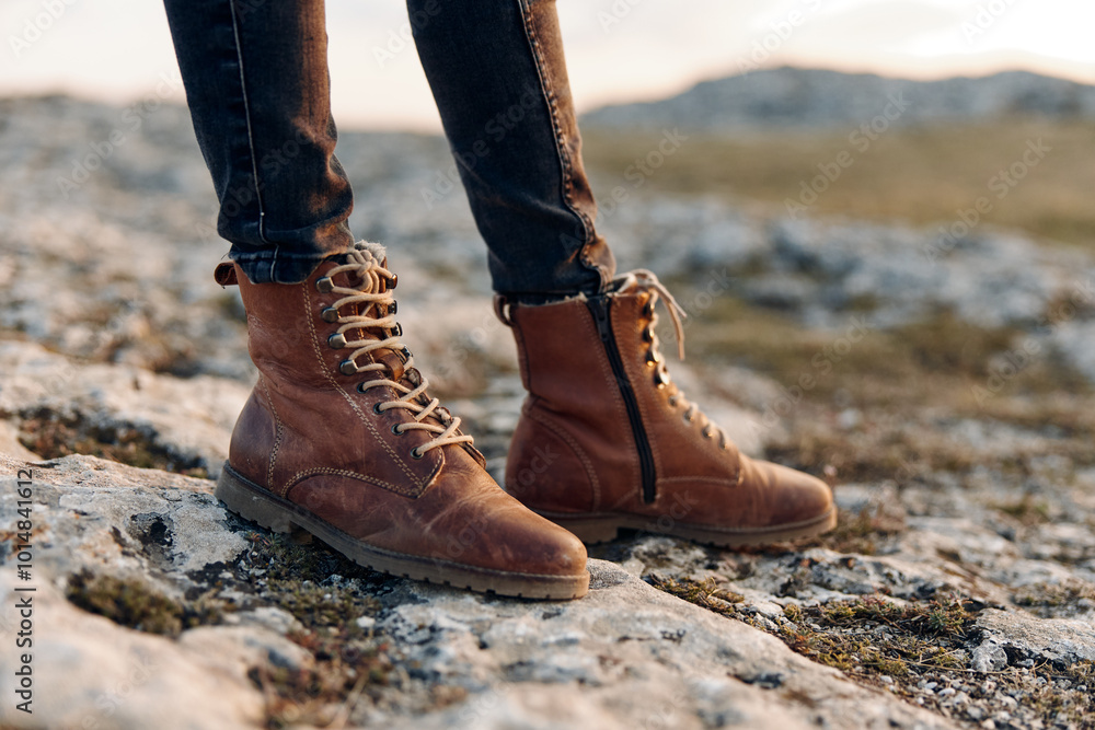 golden hour in the mountains woman in brown boots standing on rock at sunset with mountain backdrop golden hour in the mountains woman in brown boots standing on rock at sunset with mountain backdrop