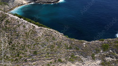 A popular tourist spot is Kelinking Beach on Nusa Penida Island, with a hiking trail down the mountain to the beach. photo