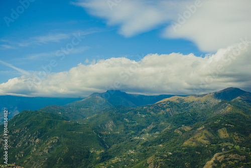 Panoramic landscape of the Italian city, photos from a drone, quadcopter, aerial photography. The city, the houses with tiled roofs, the road and the mountains. Layout. A miniature. View of Piedmont, 