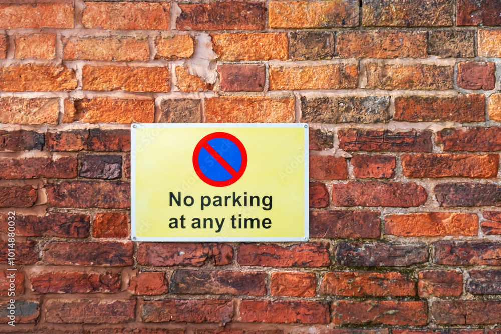 No parking sign against a brick wall No parking sign against a brick wall