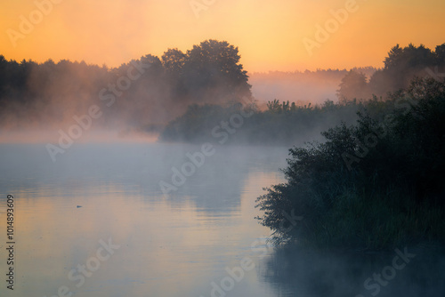 Misty Sunrise Over Tranquil Lake