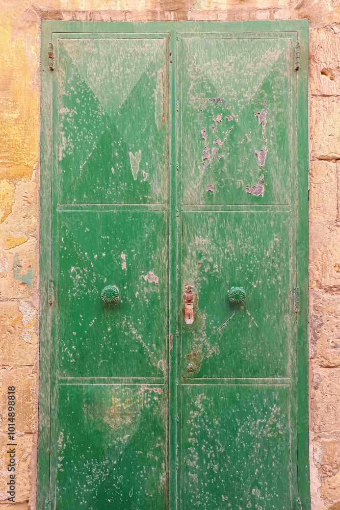 An old wooden green door in a Mediterranean setting in a historic town in Italien. An old wooden green door in a Mediterranean setting in a historic town in Italien.