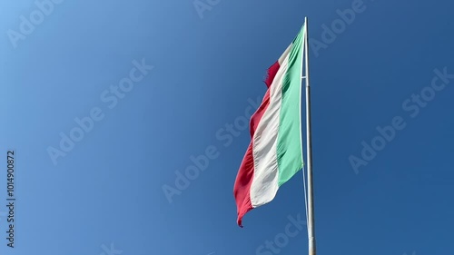 Italian flag vawing in the wind in a windy sumer day. low angle image