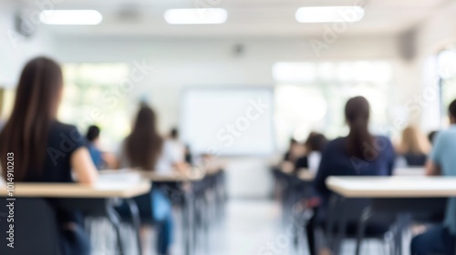 blank whiteboard on a white wall inside a classroom, defocused and blurred, students are sitting on their chairs quietly waiting for a teacher that hasn't showed up.