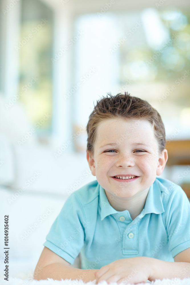 Boy, happy child and lying in home portrait, morning confidence and chilling on floor of living room. Male person, kid and comfortable on carpet in France, healthy growth and development in lounge Boy, happy child and lying in home portrait, morning confidence and chilling on floor of living room. Male person, kid and comfortable on carpet in France, healthy growth and development in lounge