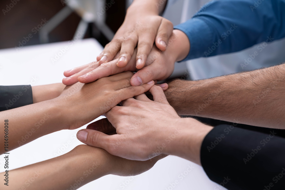Group of diverse office worker join hand together in office room symbolize business synergy and strong productive teamwork in workplace. Cooperation and unity between business employee. Prudent Group of diverse office worker join hand together in office room symbolize business synergy and strong productive teamwork in workplace. Cooperation and unity between business employee. Prudent