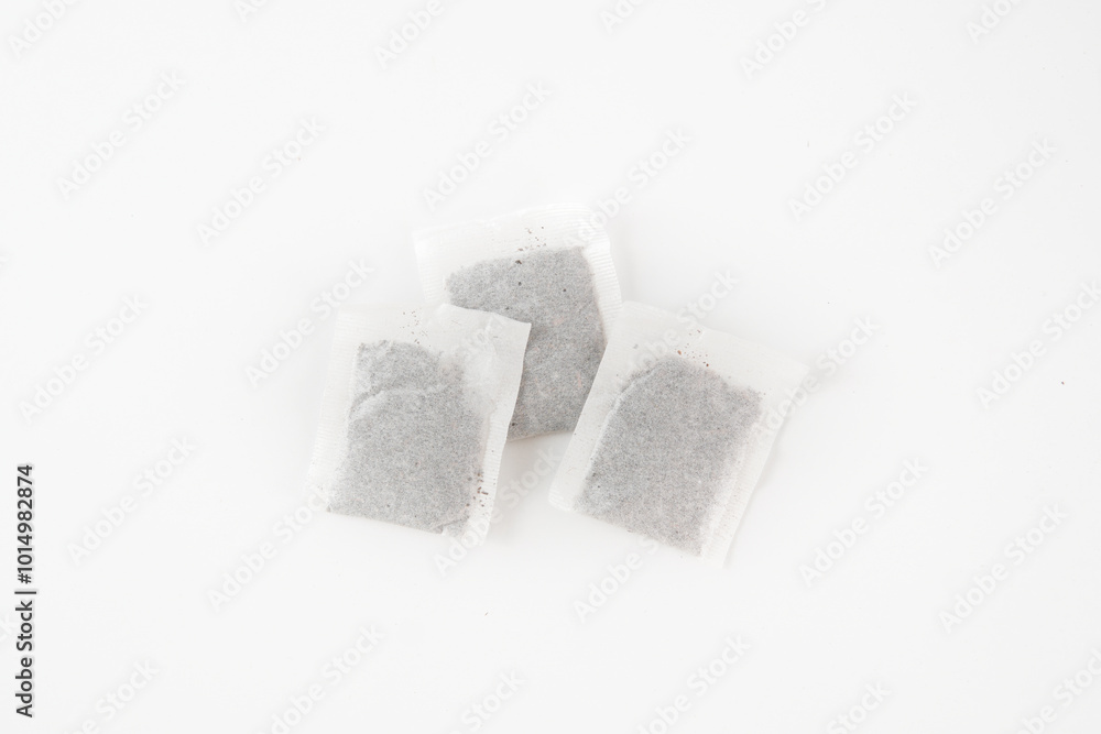 Three tea bags are sitting on a white background Three tea bags are sitting on a white background