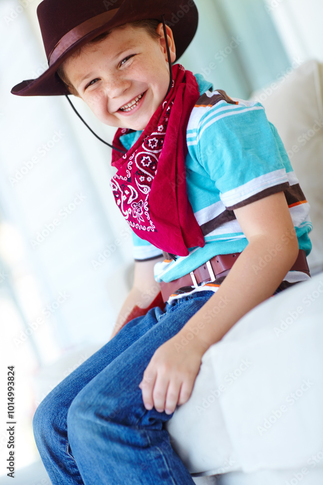 Obraz premium Portrait, cowboy or child with smile in home, childhood and dress up for halloween concert in living room. House, happy kid and fantasy with fashion for character role, cosplay and confident in Texas
