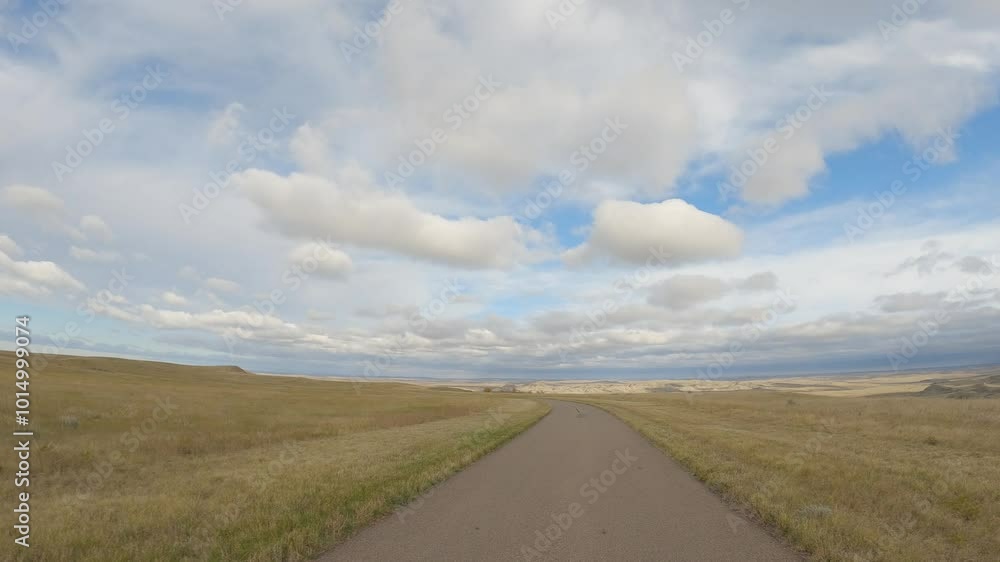 View while driving along a twisting narrow road at autumn grassland and beautiful sky
View while driving along a twisting narrow road at autumn grassland and beautiful sky
