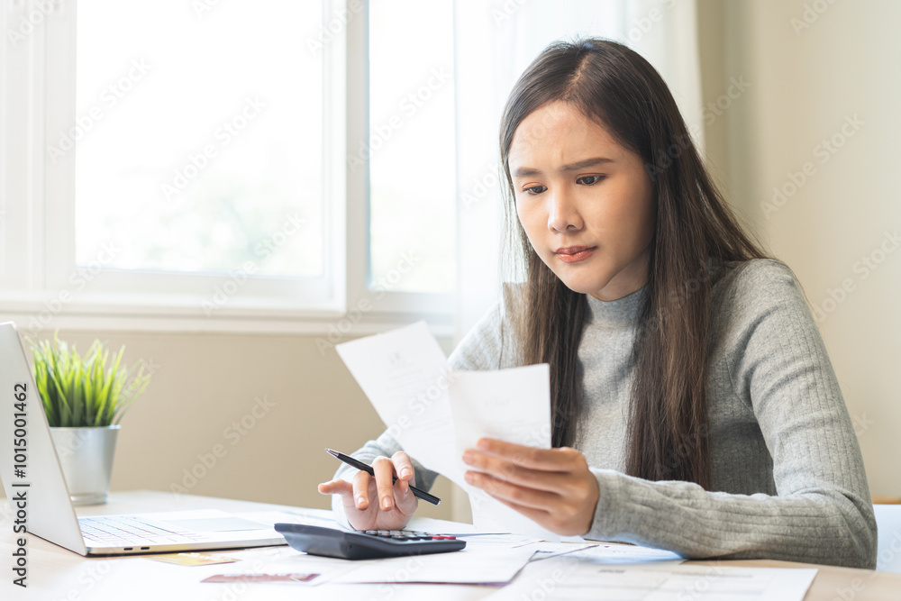 Business financial concept, owe asian young woman crisis and stressed, calculate expense, cost or budget on table at home from invoice or bill have no money to pay mortgage or loan, debt bankruptcy. Business financial concept, owe asian young woman crisis and stressed, calculate expense, cost or budget on table at home from invoice or bill have no money to pay mortgage or loan, debt bankruptcy.