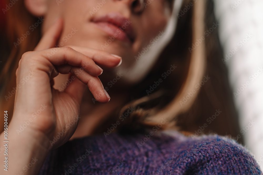 Lady touches her face, horizontal picture. A woman in purple knitted sweater with read color of hair touches her cheek, closeup photo. Sign of female flirting with a man. Lady touches her face, horizontal picture. A woman in purple knitted sweater with read color of hair touches her cheek, closeup photo. Sign of female flirting with a man.