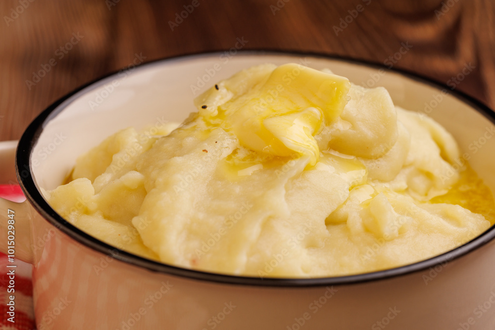 Creamy Mashed Potatoes with Melting Butter Pearl on Dark Wooden Table Creamy Mashed Potatoes with Melting Butter Pearl on Dark Wooden Table